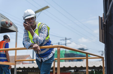 Engineer Team Inspecting Freight Train Cars and Cargo, Engineers Discussing Project Progress at Construction Site