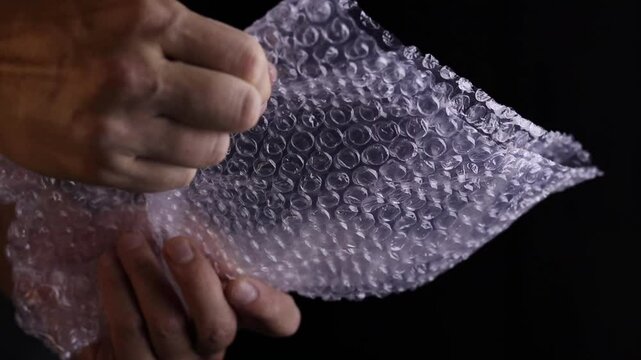 man hand squeeze bubble papper for fun