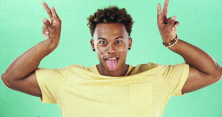 Funny face, portrait and tongue out with black man on green background for comedy or humor as...