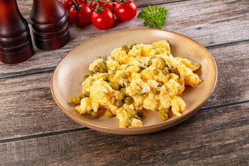 Scrambled egg omelet with green peas