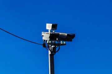 Urban surveillance and traffic monitoring cameras on metal poles in Brazil. Devices help improve public safety, vehicle control, and city management through smart technology.
