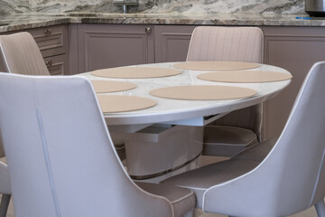 Modern kitchen interior with round dining table and chairs