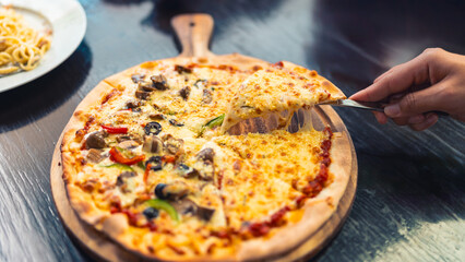 Freshly baked and ready to serve mini pizzas made in our kitchen every day. The concept of family dining together, family happiness with food.