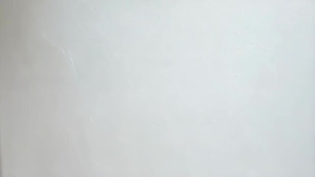 Abstract white plaster wall background with subtle texture and brush strokes, suitable for artistic presentation or backdrop.