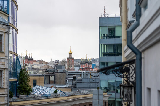 View of Russian Cityscape featuring modern glass building, Orthodox Church and vintage architecture