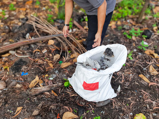 Man Collecting Plastic Waste into Sack to Stop Pollution