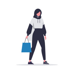 Obraz premium a woman in a trendy outfit carrying a designer shopping bag