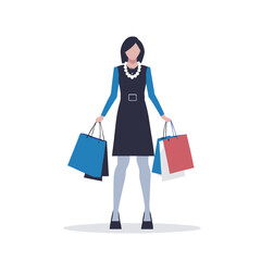 a woman in a trendy outfit carrying a designer shopping bag