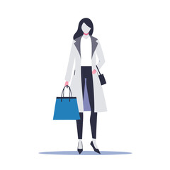 a woman in a trendy outfit carrying a designer shopping bag
