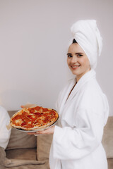 Woman Relaxing in Bathrobe Holding Pizza in Comfortable Lifestyle Moment