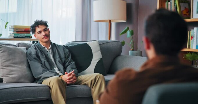 Counseling, listening and student on sofa with therapist for help, support and advice for college stress. Mental health, therapy and guidance counsellor with man for exam anxiety, burnout and failure