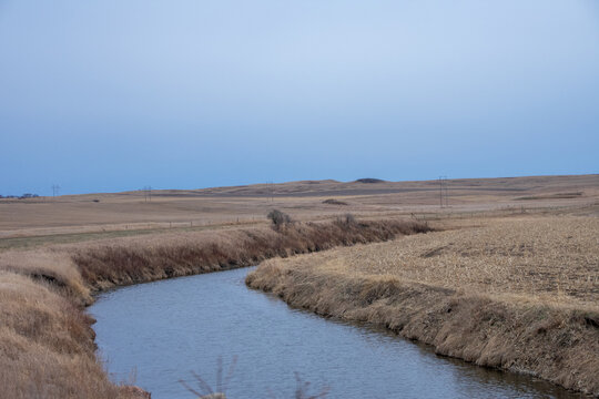 small creek cutting through the farm land