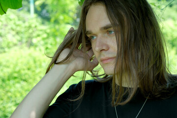 Young man enjoys the tranquility of nature in a lush green setting