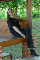 Young person enjoying a quiet moment in a sunlit shelter