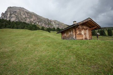 small house over a mountain pasture in Dolomites with wonderful panorama