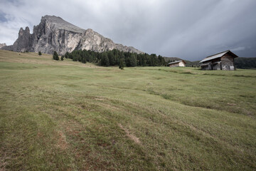 small house over a mountain pasture in Dolomites with wonderful panorama