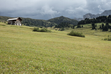 small house over a mountain pasture in Dolomites with wonderful panorama