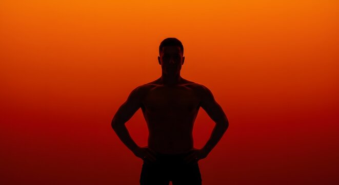 Silhouette of Muscular Man Against Orange Background