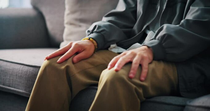 Hands, nervous or man on sofa with anxiety for trauma, mental health or overthinking with stimming. Worry, person with depression and fidget in home with stress, overwhelmed or panic attack in lounge