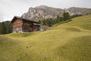 small house over a mountain pasture in Dolomites with wonderful panorama