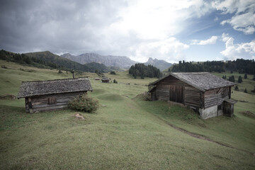 small house over a mountain pasture in Dolomites with wonderful panorama