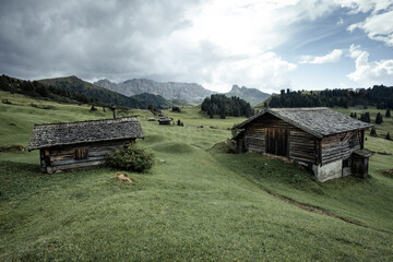 small house over a mountain pasture in Dolomites with wonderful panorama