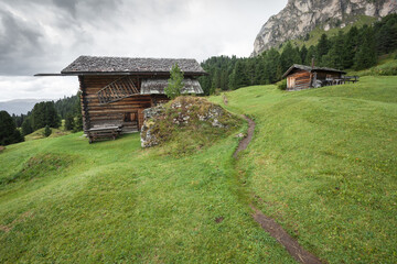 small house over a mountain pasture in Dolomites with wonderful panorama