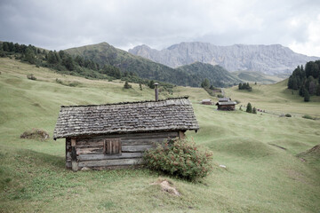 small house over a mountain pasture in Dolomites with wonderful panorama