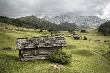 small house over a mountain pasture in Dolomites with wonderful panorama