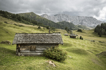 small house over a mountain pasture in Dolomites with wonderful panorama