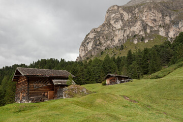 small house over a mountain pasture in Dolomites with wonderful panorama