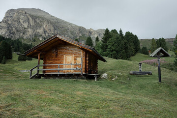 small house over a mountain pasture in Dolomites with wonderful panorama