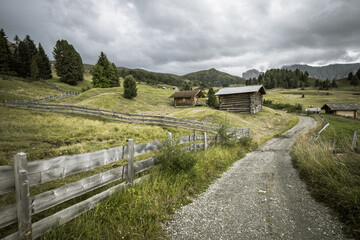small house over a mountain pasture in Dolomites with wonderful panorama
