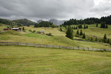 small house over a mountain pasture in Dolomites with wonderful panorama