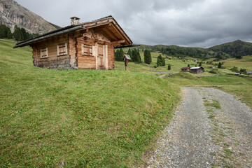 small house over a mountain pasture in Dolomites with wonderful panorama