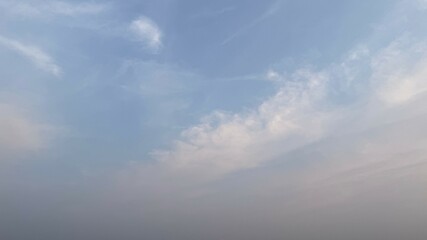 Wispy Clouds in a Pale Blue Sky with Hazy Lower Atmosphere, Natural Landscape