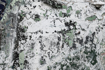 Abstraction of crumbling graffiti on a city street wall. Colorful abstract background. Old, cracked, peeling paint on the wall as a background.Abstract background in neutral calm colors.