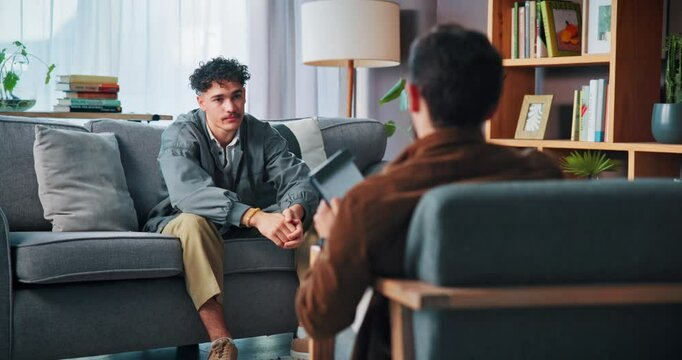 Counseling, anxiety and student on sofa with therapist for help, support and advice for college stress. Mental health, therapy and guidance counsellor with man worry for exams, burnout and failure