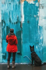 Woman Painting Blue Wall with Dog Looking on