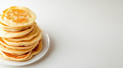Stack of Freshly Cooked Pancakes on a White Plate Isolated Background