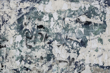  Abstraction of crumbling graffiti on a city street wall. Colorful abstract background. Old, cracked, peeling paint on the wall as a background.Abstract background in neutral calm colors.