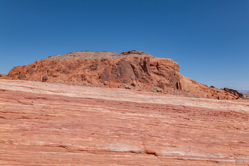 Fototapeta premium red Aztec Sandstone outcrops, Early Jurassic geological formation of primarily eolian sand. Fire Wave Trail, Valley of Fire State Park, Clark County, Nevada geology. 
