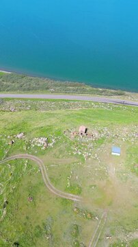A small Church on top of a mountain. St. Hovhannes Church in Sevan taken with drone
