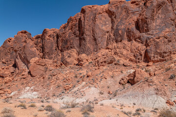Fototapeta premium Desert varnish, red Aztec Sandstone outcrops with Willow Tank Formation. Fire Wave Trail, Valley of Fire State Park, Clark County, Nevada geology.