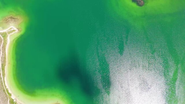Aerial view of a tropical island with white sand beaches and volcanic features, captured by drone. Chayeri Island, Sevan, Armenia 