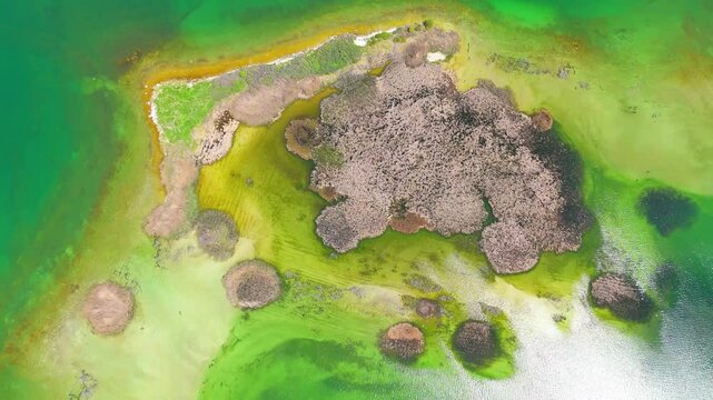 Aerial view of a tropical island with white sand beaches and volcanic features, captured by drone. Chayeri Island, Sevan, Armenia 