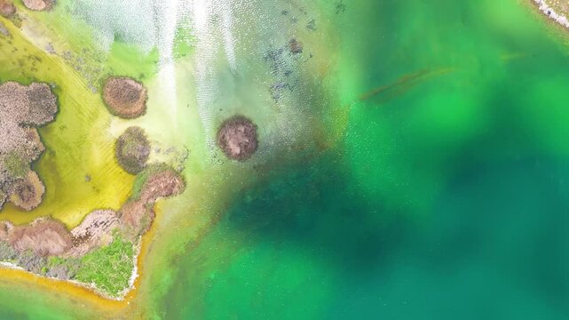 Aerial view of a tropical island with white sand beaches and volcanic features, captured by drone. Chayeri Island, Sevan, Armenia 