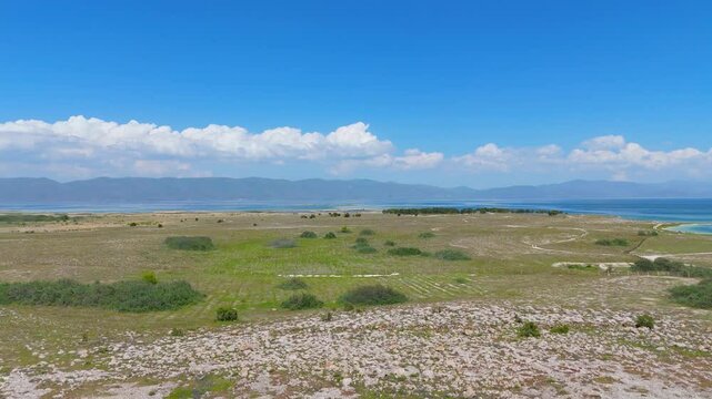 Aerial view of a tropical island with white sand beaches and volcanic features, captured by drone. Chayeri Island, Sevan, Armenia 