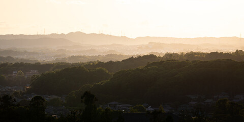 Panoramic view on the Sunset over hills in Japan; Japanese sunset on a forest