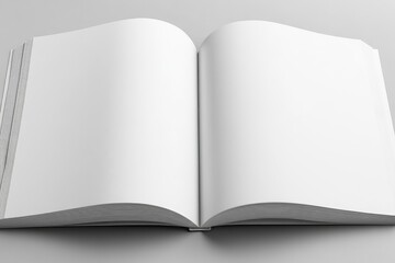 A pristine, open book with blank, white pages rests on a light gray surface, showcasing its texture and spine
